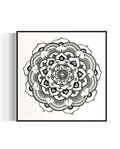 Black and white mandala art print in a black frame on a white background