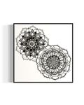 Framed artwork of two black and white mandala flower designs on a white background