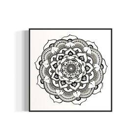 Black and white mandala art print in a black frame on a white background
