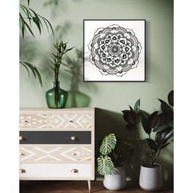 Black and white mandala art print in a black frame on a white background