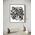 Framed black and white abstract artwork filled with eyes and whimsical linework patterns on a white background